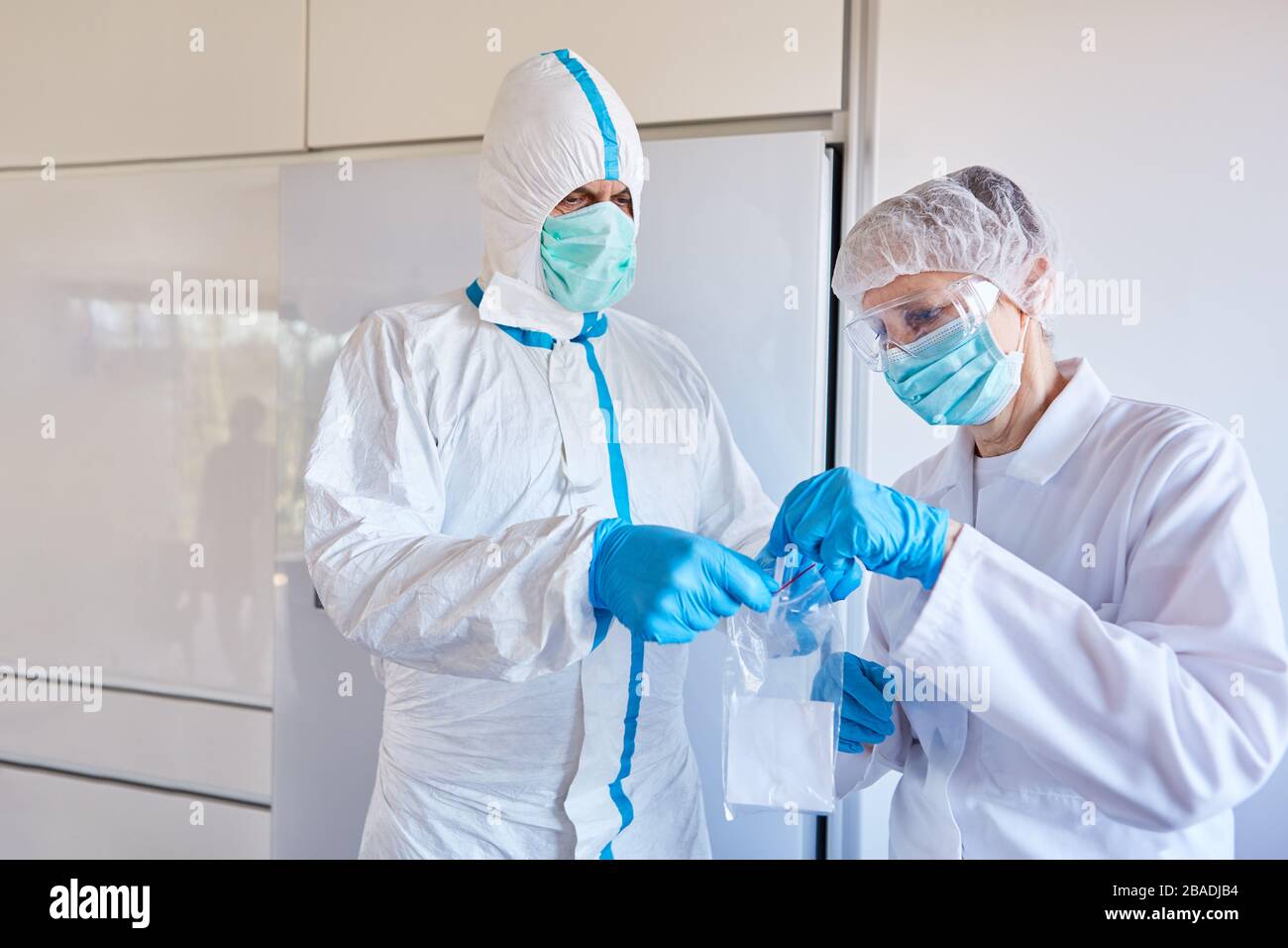 Professionisti del settore medico con test di Coronavirus Covid-19 come campione di saliva in laboratorio Foto Stock