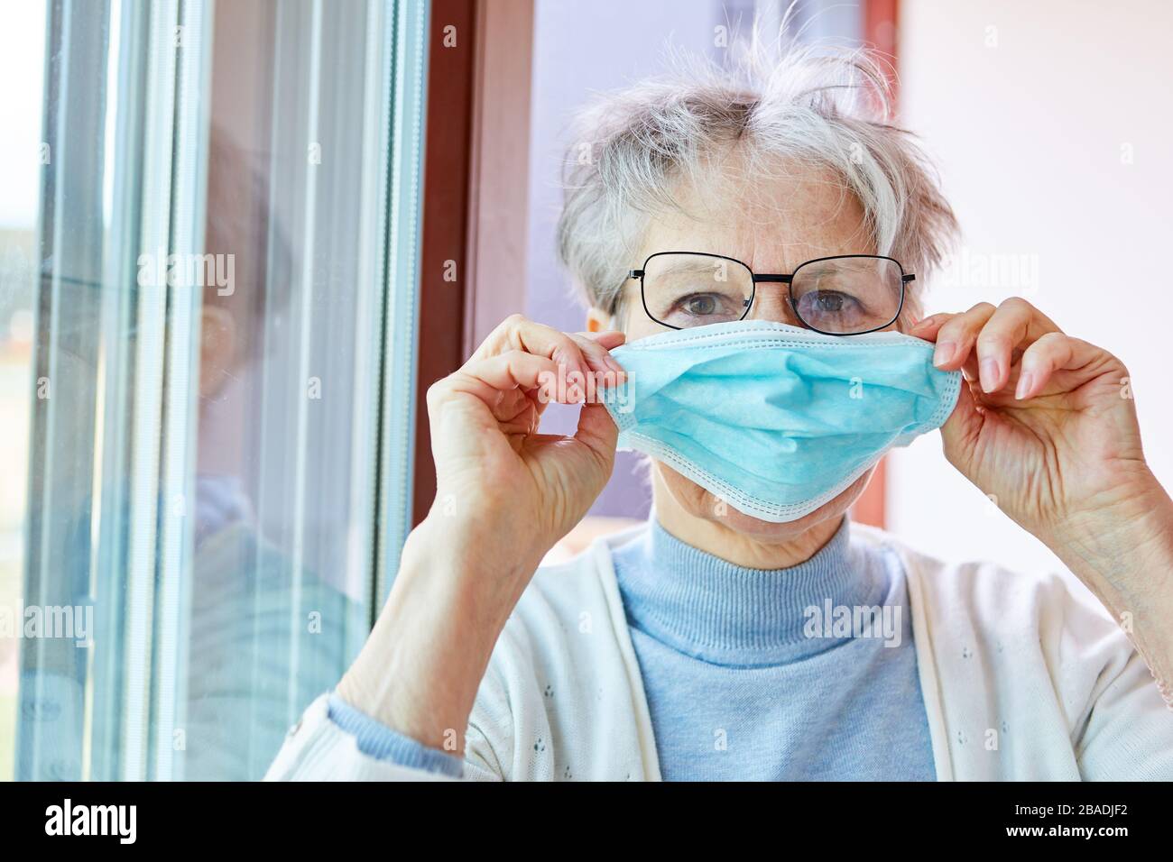 Donna anziana in quarantena come paziente Covid-19 Foto Stock