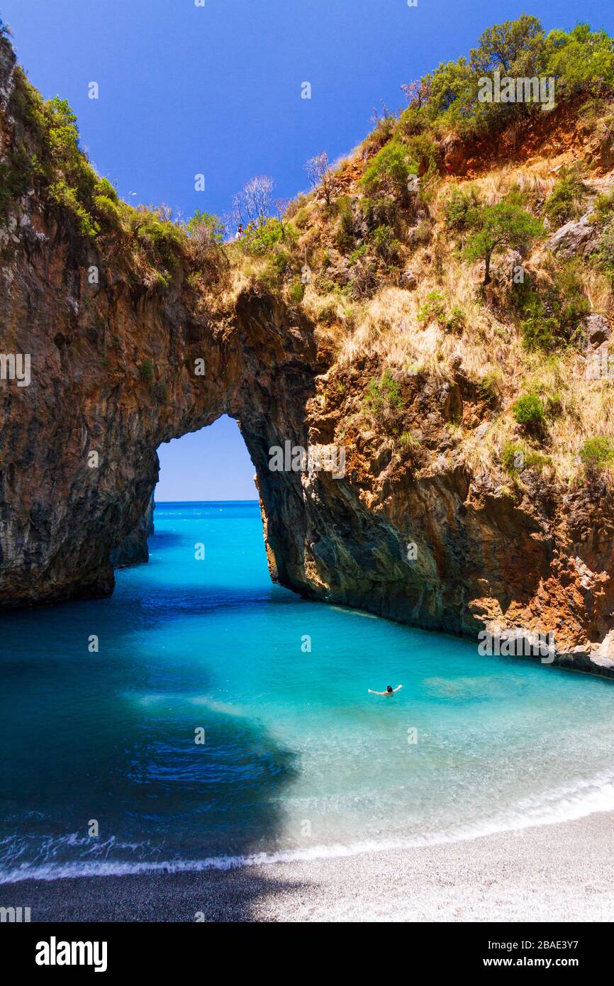 Donna che nuota sul Mar mediterraneo dell'Arco Magno, un bel posto vicino alla famosa Tropea (Calabria, Italia) Foto Stock