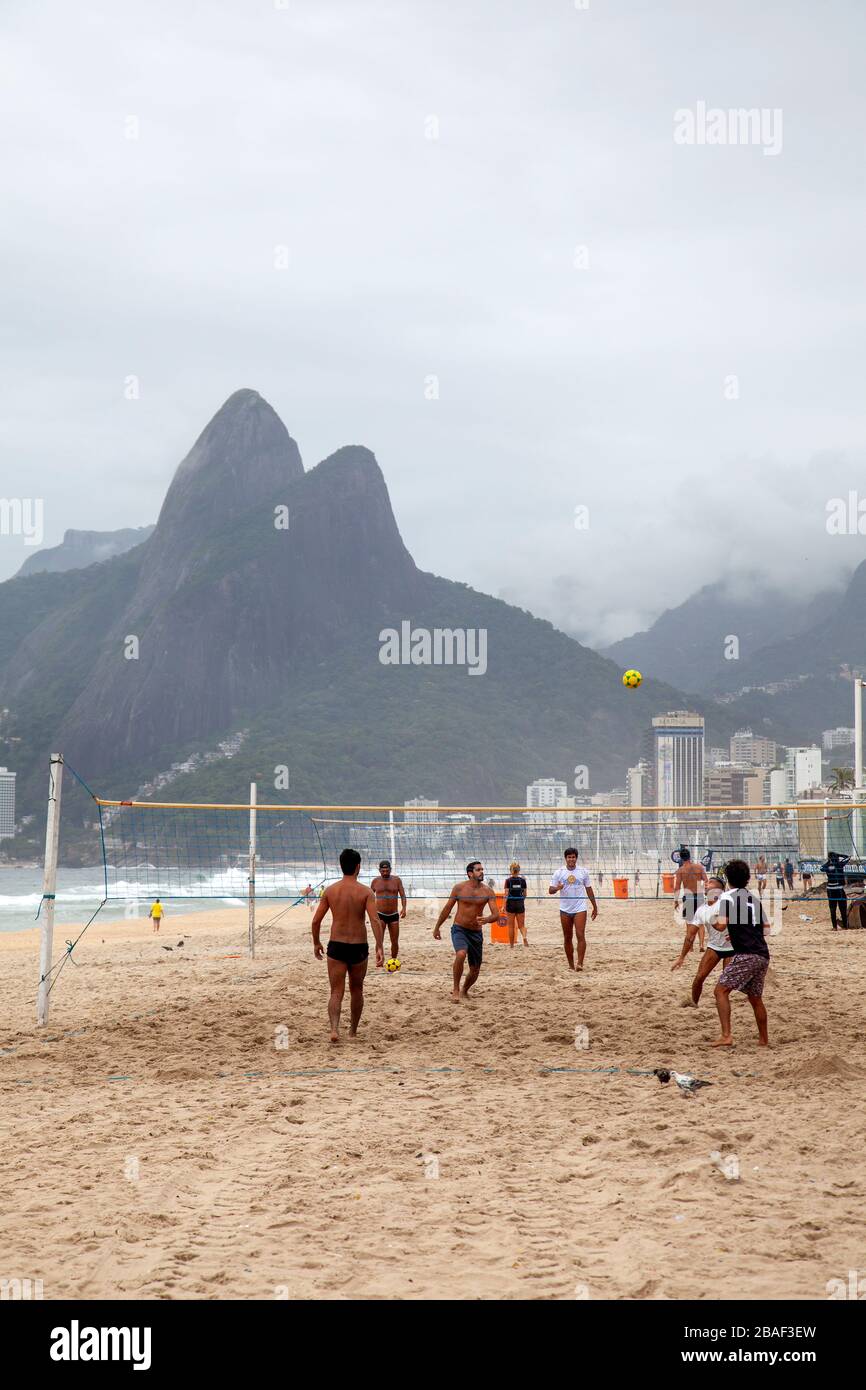 Uomini che giocano a Volley in mattinata sulla spiaggia di Ipanema - Rio, Brasile Foto Stock