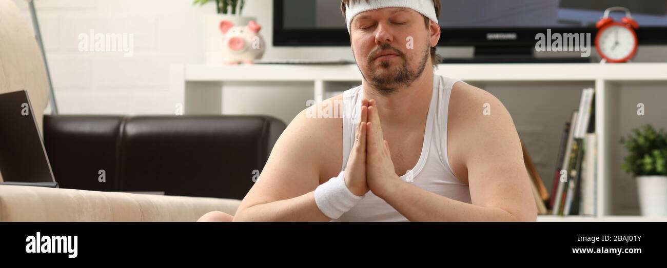 Giovani attraenti uomo fitness giace su un tappeto di grasso con Foto Stock