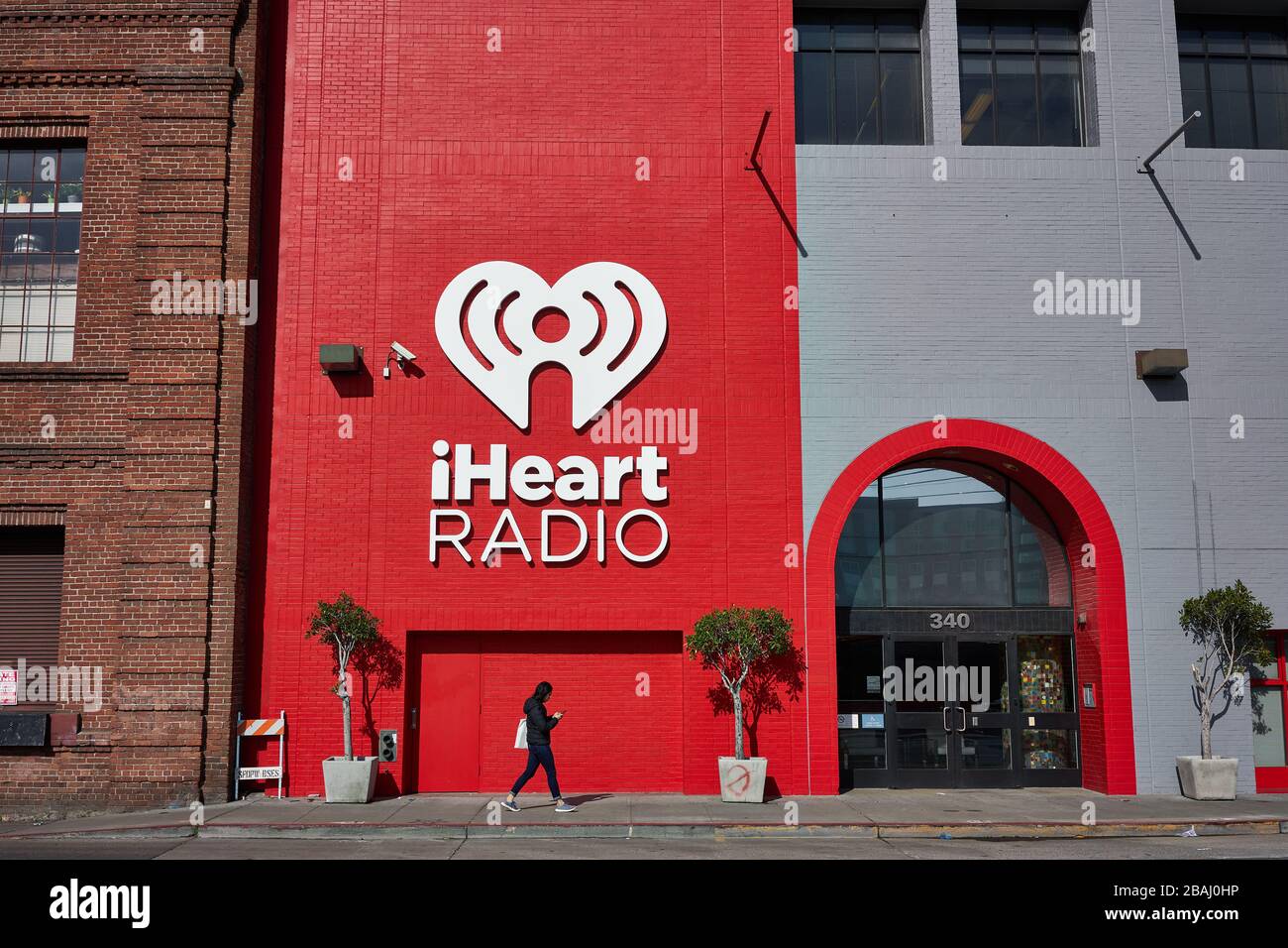 Una donna passa davanti all'ufficio iHeartMedia nel quartiere di Soma a San Francisco, California, domenica 9 febbraio 2020. Foto Stock