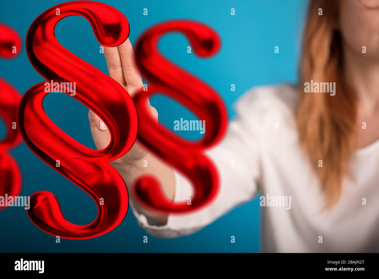 Un segno di legge di paragrafo in mano digitale Foto Stock