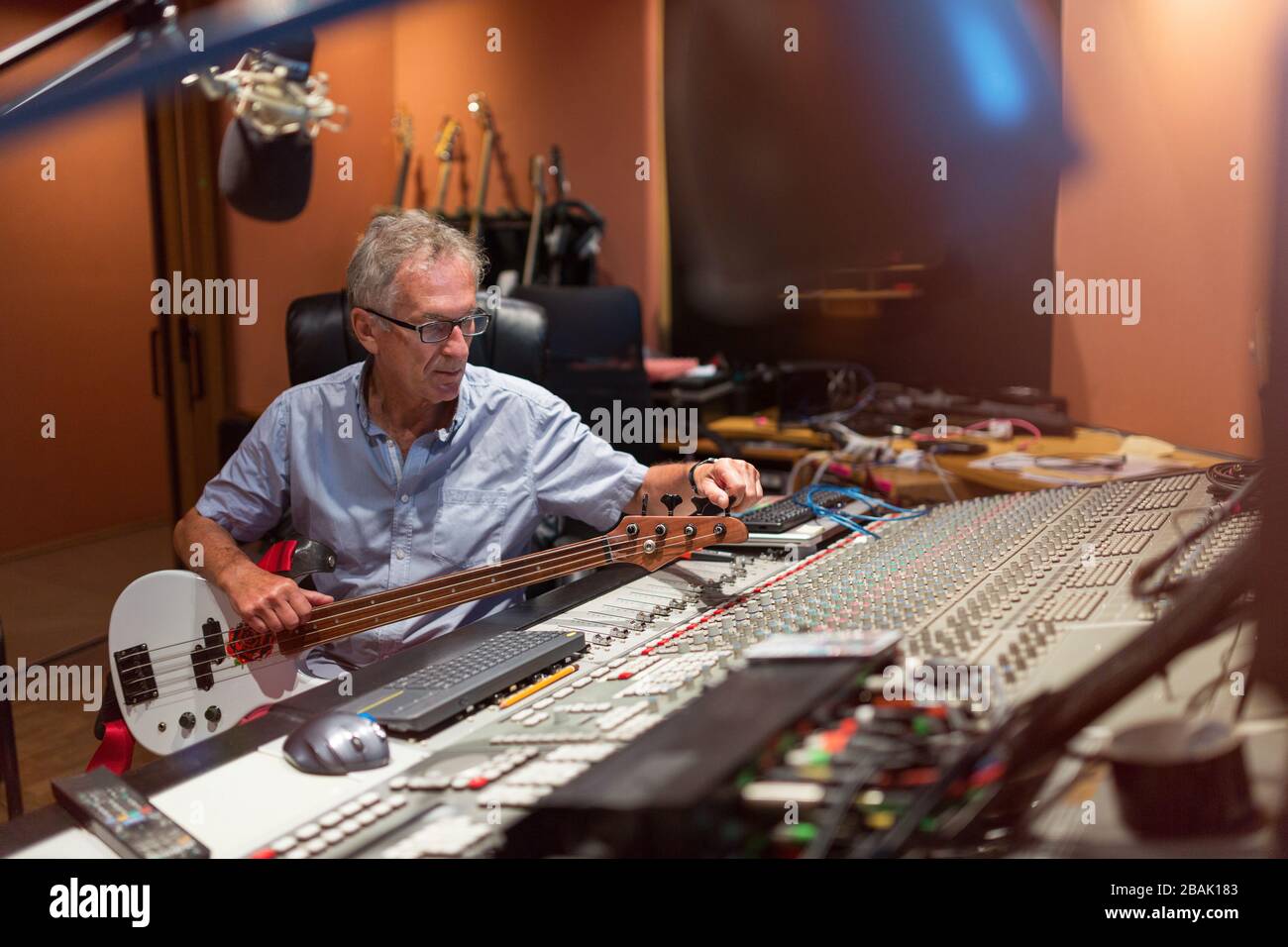 Uomo maturo alla scrivania di missaggio in uno studio di registrazione Foto Stock