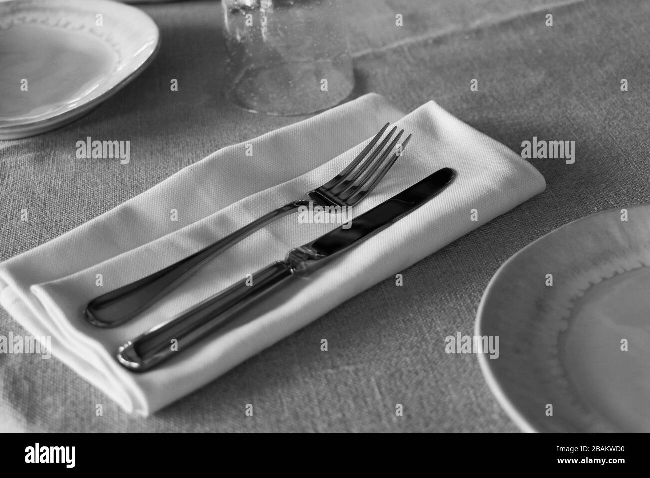 posate da ristorante, coltello e forchetta su un tavolo con tovagliolo Foto Stock