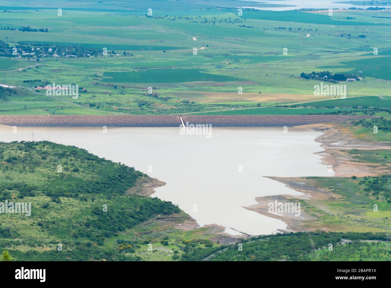 Vista aerea su una grande diga o deposito di acqua a Kwazulu Natal, Sud Africa durante la stagione estiva verde e bagnata che mostra il paesaggio scenico Foto Stock