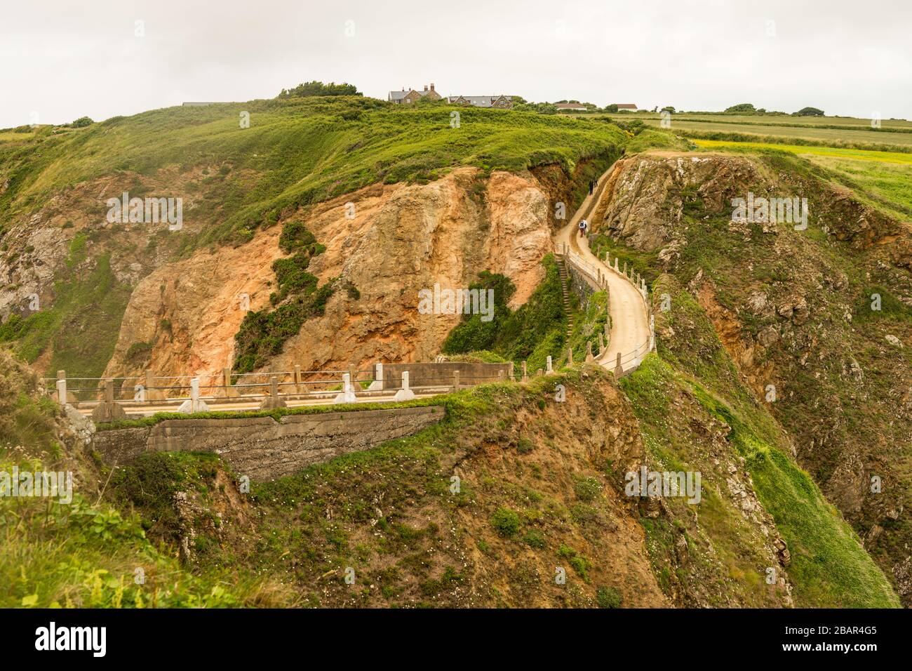 La Coupée, uno stretto istmo di terra tra il Grande Sark e Little Sark (primo piano) nelle Isole del canale del Regno Unito. Strada costruita nel 1945 dai prigionieri tedeschi. Foto Stock