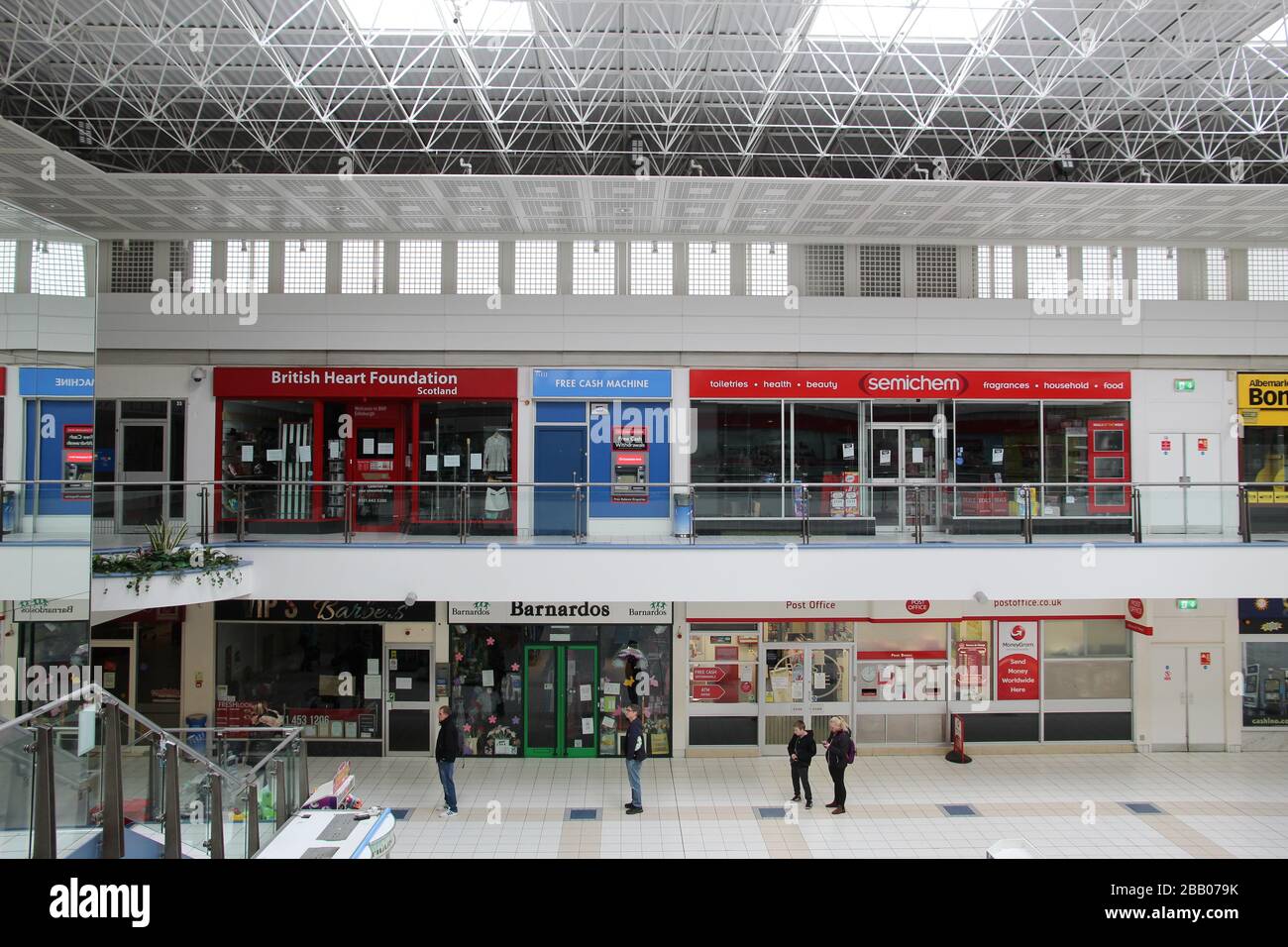 Persone che si allontanano in una coda in un centro commerciale Foto Stock