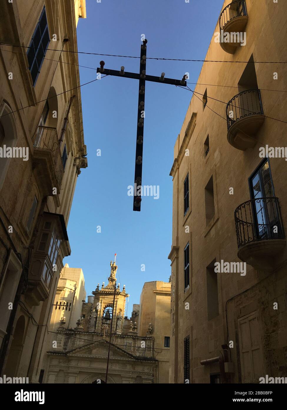 Croci sospese da edifici, per feste religiose, a Valletta, a Malta, il 28 febbraio 2020. Foto Stock