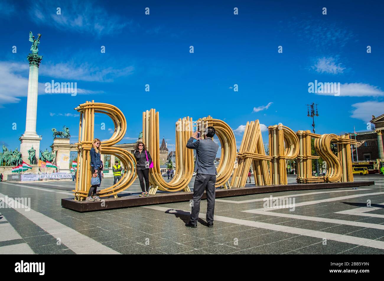 I turisti possono scattare foto con un grande cartello di Budapest in legno presso la Piazza degli Eroi di Budapest, Ungheria. Foto Stock