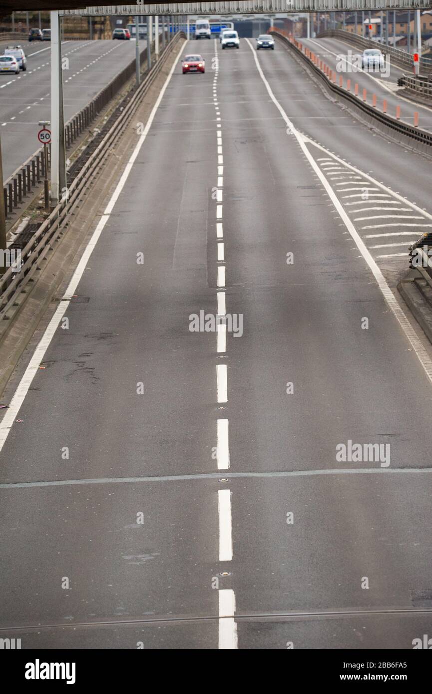 Glasgow, Regno Unito. 30th Mar, 2020. Nella foto: L'autostrada M8 che passa sopra il Kingston Bridge, il ponte degli affari della Scozia, è vista con luce libera e traffico libero che normalmente sarebbe bloccato in un ingorgo. Il Kingston Bridge gestisce normalmente 150.000 veicoli al giorno in normali operazioni, tuttavia, a causa del blocco impostato dal governo britannico, il numero di veicoli è diminuito notevolmente. Credito: Colin Fisher/Alamy Live News Foto Stock