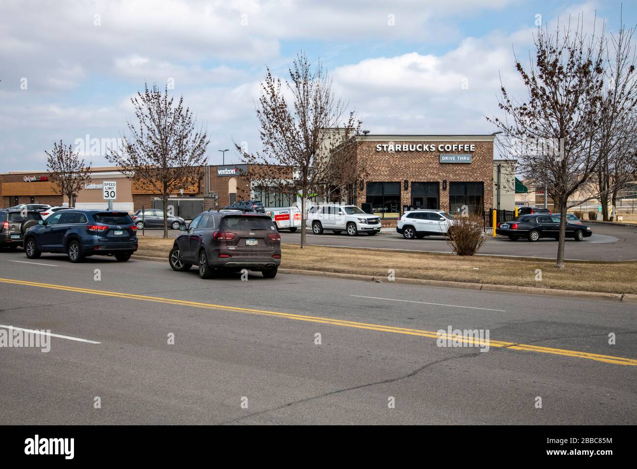 Roseville, Minnesota. Il traffico fa ritorno al punto di prelievo Starbucks dopo che l'epidemia di coronavirus ha chiuso l'area pranzo interna. Foto Stock