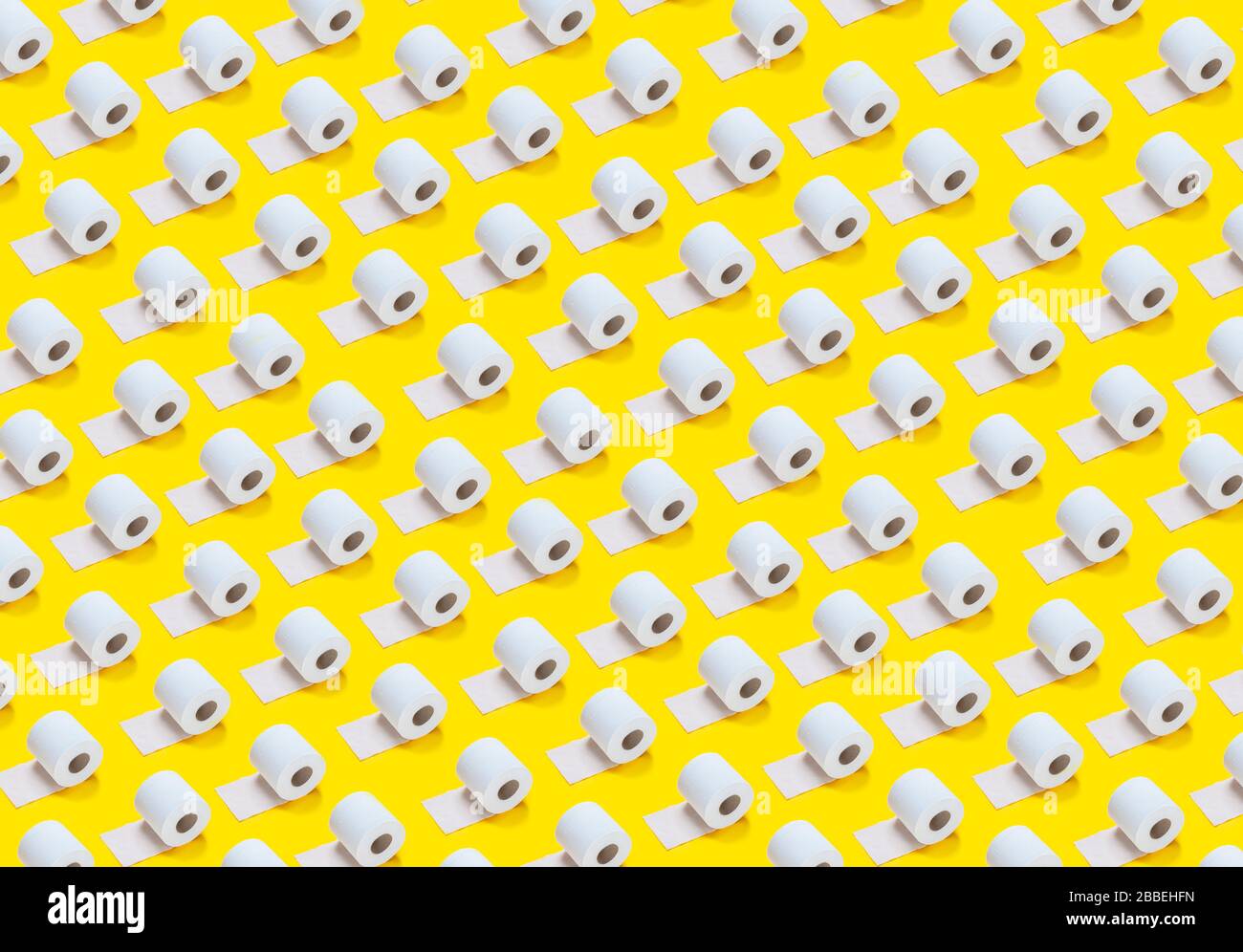 un sacco di rotoli di carta igienica su uno sfondo giallo Foto Stock