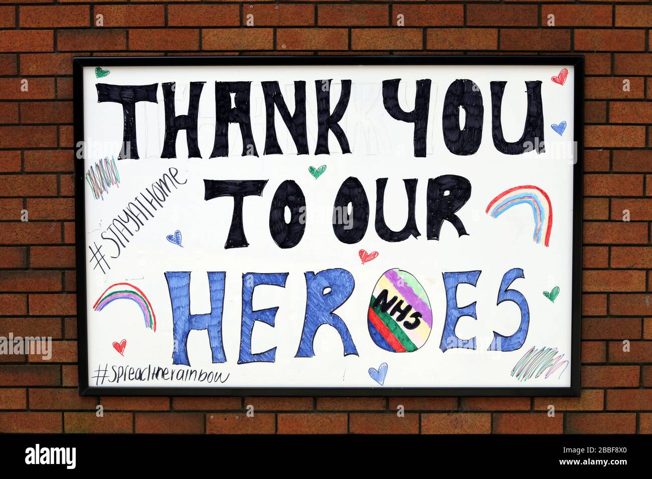 Grazie scritto a mano ai nostri eroi NHS segno sul muro di mattoni Foto Stock