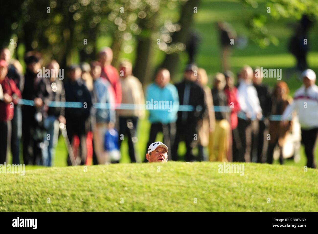 Lee Westwood dell'Inghilterra è un membro di un bunker profondo mentre osserva un approccio girato durante il Day One del Campionato PGA BMW 2013, al Wentworth Golf Club. Foto Stock