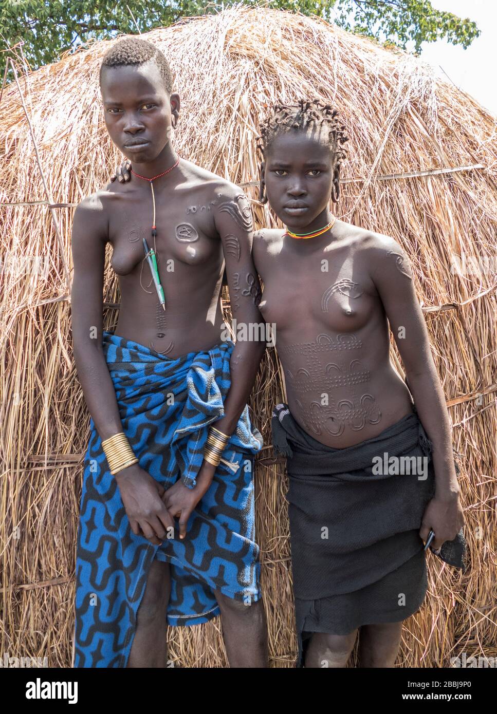 Due tradizionali giovani Mursi Tribe Donne con cicatrici di bellezza e indossare ornamentazione tradizionale nel villaggio Mursi nella Valle Omo nel Sud E. Foto Stock