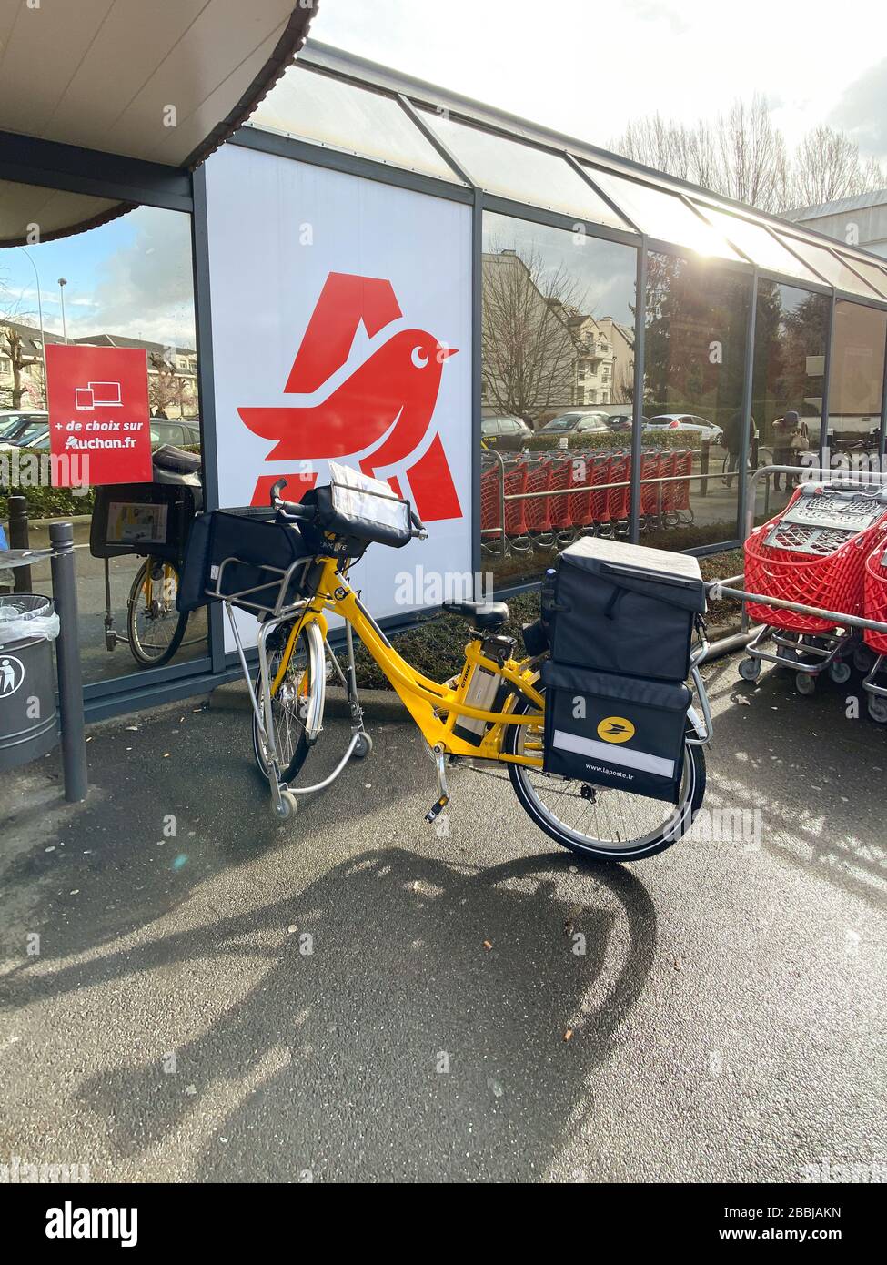 Strasburgo, Francia - 26 febbraio 2020: Giallo la Poste posta lettere di  consegna della bicicletta elettrica di fronte al supermercato Auchan vuoto  Foto stock - Alamy