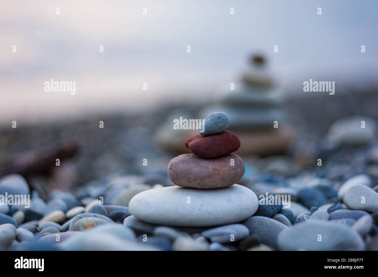 Pila di pietre zen sulla spiaggia ghiaiosa Foto Stock