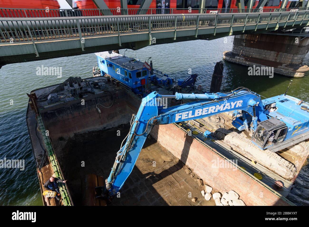 Vienna, Vienna: Escavatore della società Felbermayr riempie le pietre alle fondazioni delle strutture di ponte subacqueo al ponte Nordbahnbrücke per la protec Foto Stock