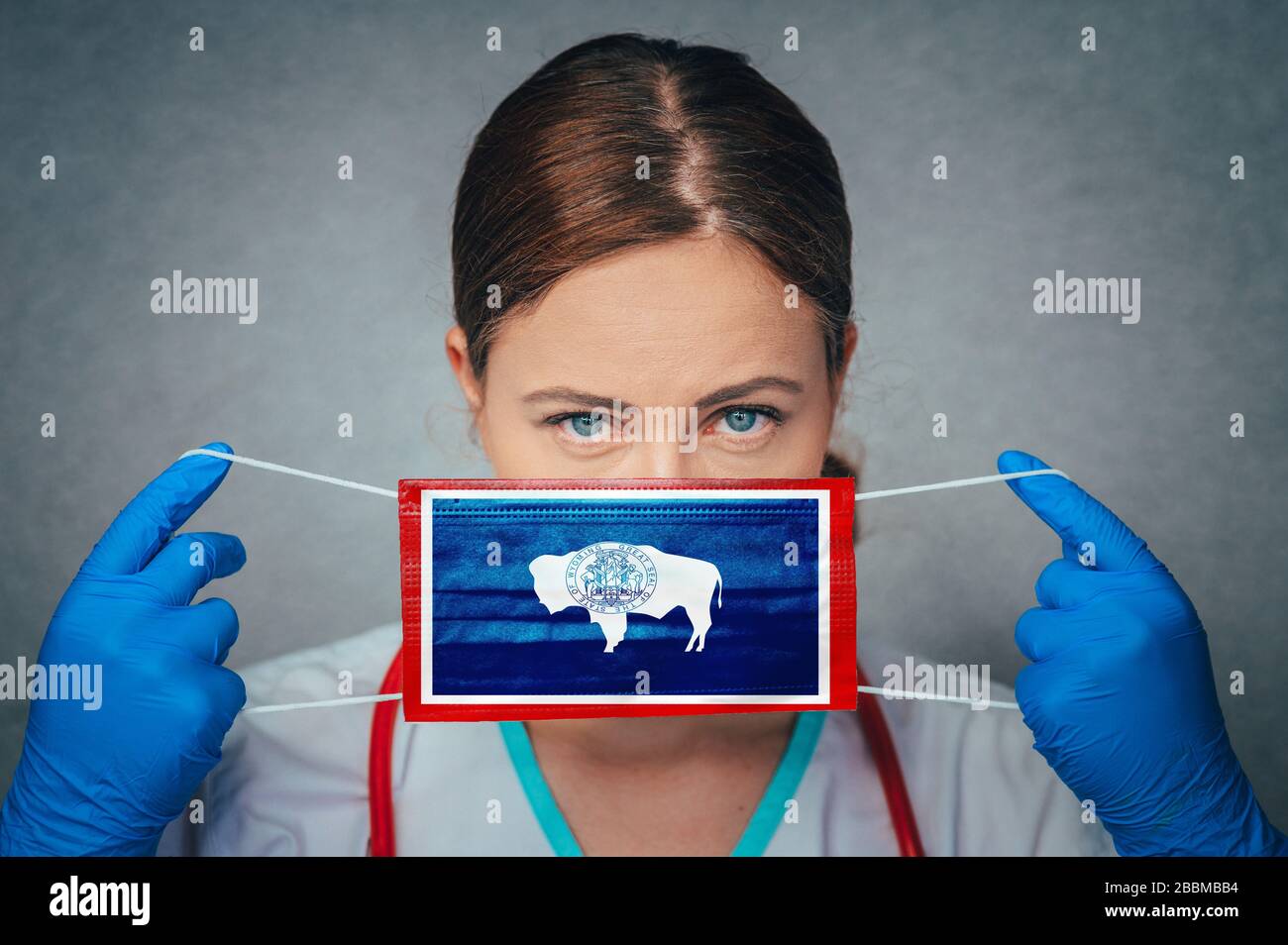 Coronavirus negli Stati Uniti, Wyoming, Female Doctor Portrait, Proteggi la maschera medica chirurgica del viso con la bandiera del Wyoming. Malattia, virus Covid-19 in Wyoming Foto Stock