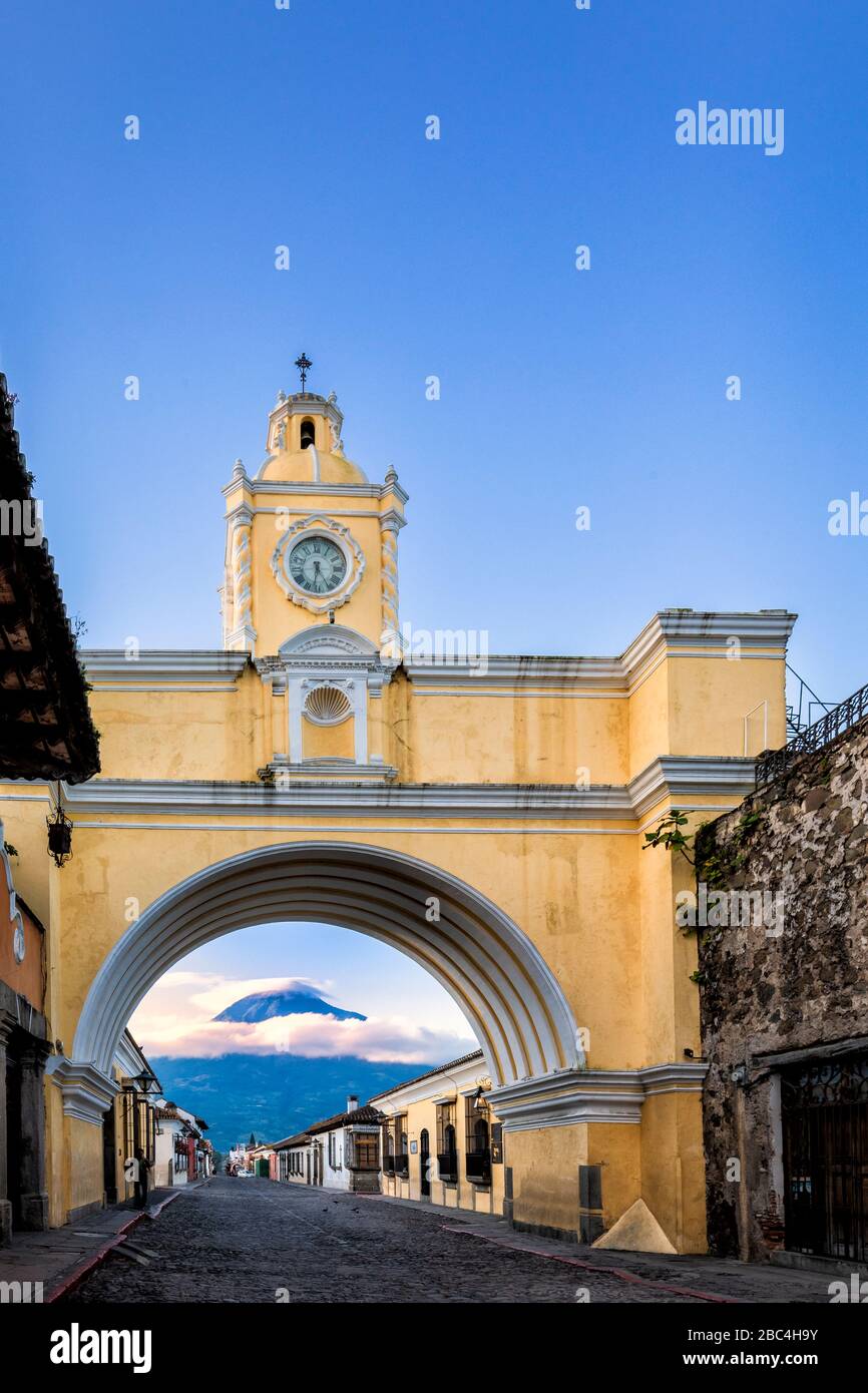 L'iconico arco di Santa Catalina ad Antigua, Guatemala, con il vulcano Agua sullo sfondo. Foto Stock