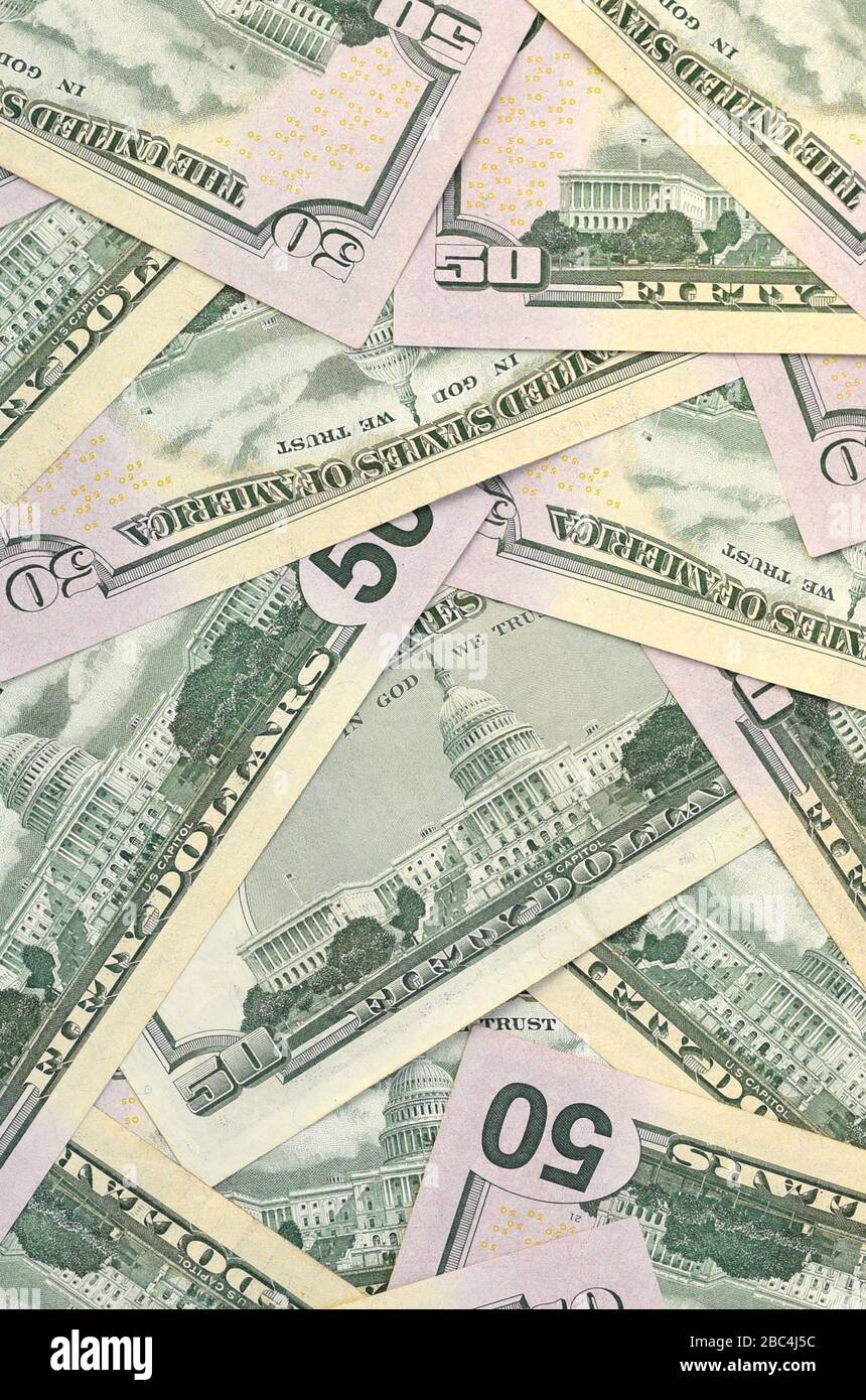 Molte banconote da cinquanta dollari statunitensi su una superficie piana di fondo vicina. Vista dall'alto a disposizione piatta. Successo astratto o concetto di business Foto Stock