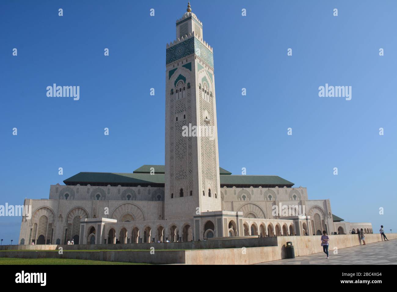 Drammatico scatto esterno della Moschea di Hassan II, Casablanca, Marocco, che mostra le enormi dimensioni dell'edificio rispetto alla gente. Foto Stock