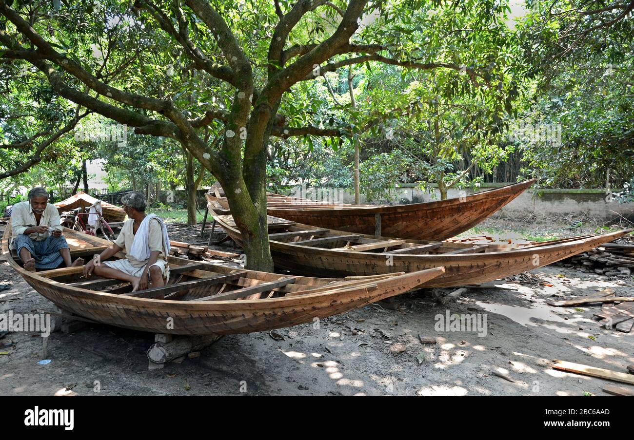 La gente del villaggio sta facendo la barca di legno al villaggio remoto dell'India. Foto Stock