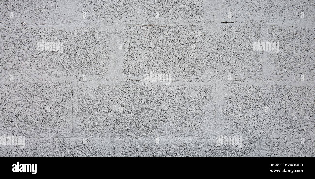 Mattoni grigi blocco di cemento parete fondo piastrelle di cemento rivestimento senza cuciture texture Foto Stock