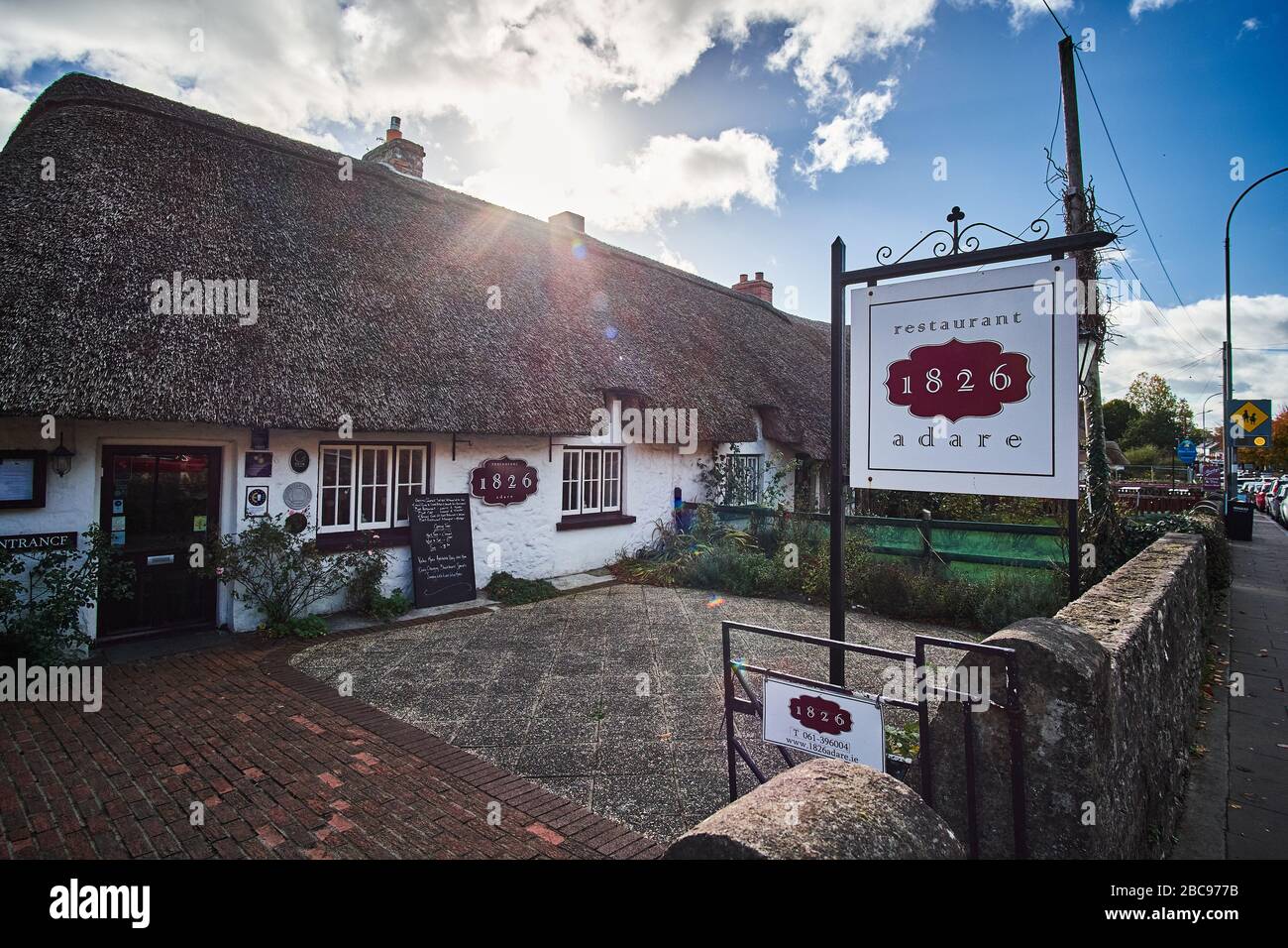 1826 Ristorante in Adare Irlanda contea Clare con cielo blu e raggi di sole. Foto Stock