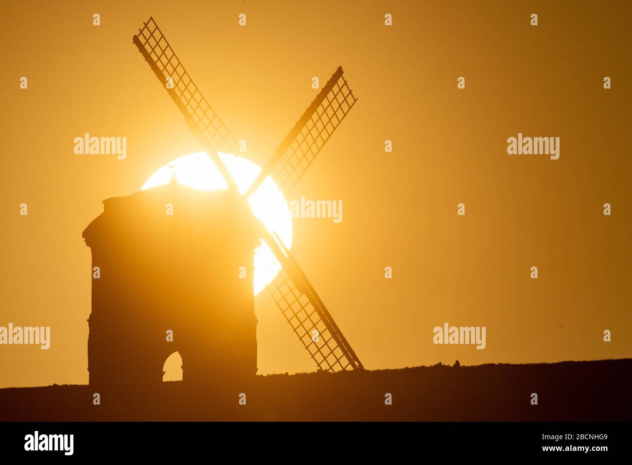 Il sole sorge su Chesterton Windmill nel Warwickshire. Foto Stock