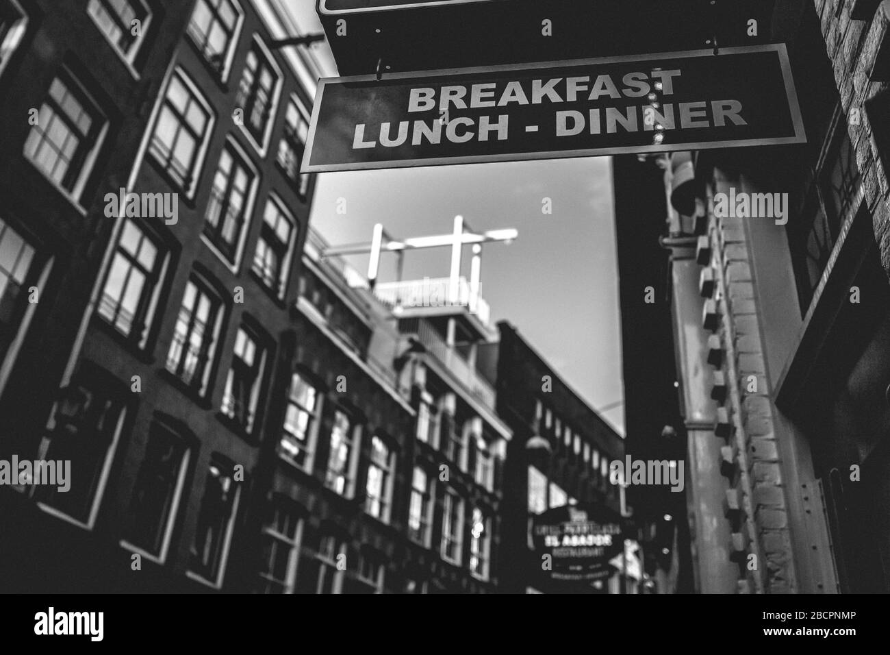 Architettura della città vecchia con colazione, pranzo e cena, insegna nella Warmoesstraat ad Amsterdam, Paesi Bassi Foto Stock