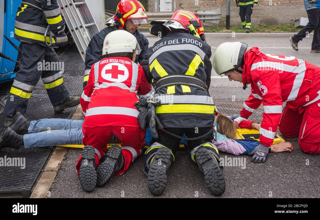 Il personale del servizio di emergenza libera un conducente ferito sulla scena di un incidente stradale durante un esercizio di formazione. Vigili del fuoco, paramedici e Italia Foto Stock