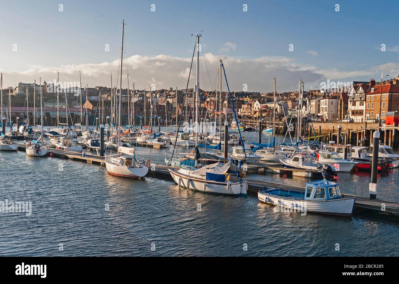 Città costiera di mare con porto turistico pieno di yacht a vela di piacere Foto Stock