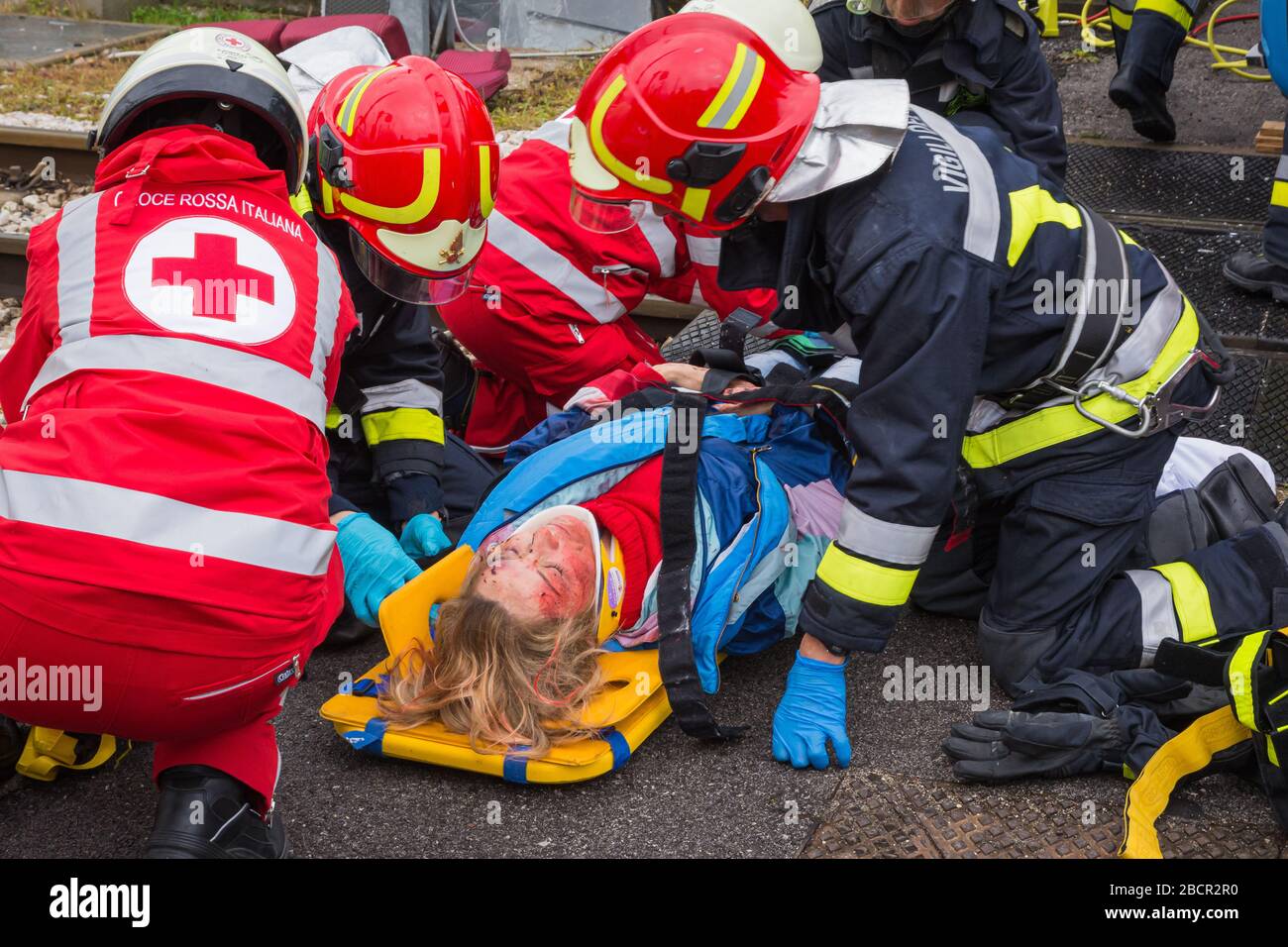 Il personale del servizio di emergenza libera un conducente ferito sulla scena di un incidente stradale durante un esercizio di formazione. Vigili del fuoco, paramedici e Italia Foto Stock