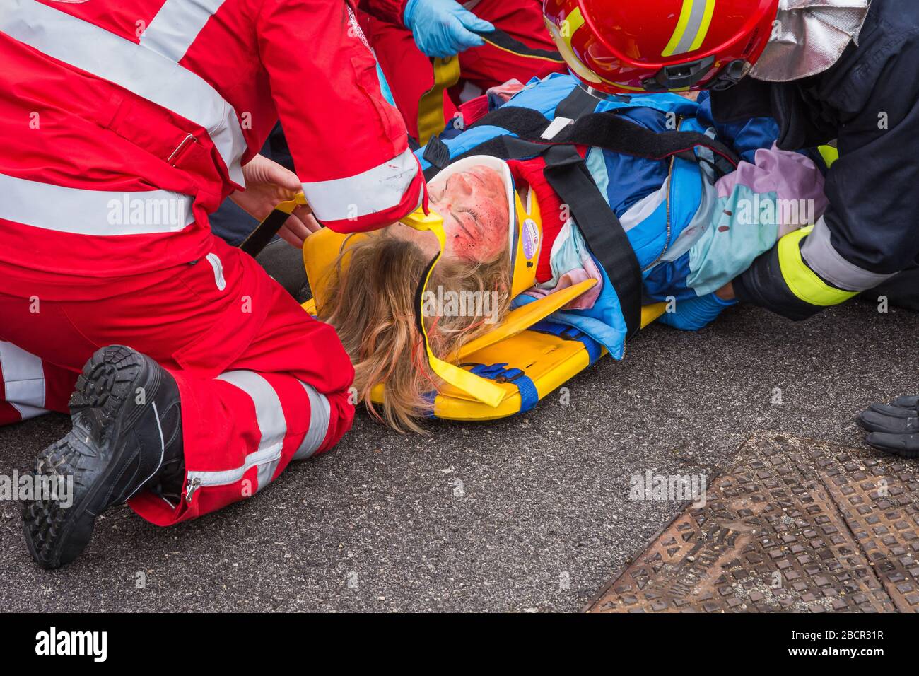 Il personale del servizio di emergenza libera un conducente ferito sulla scena di un incidente stradale durante un esercizio di formazione. Vigili del fuoco, paramedici e Italia Foto Stock