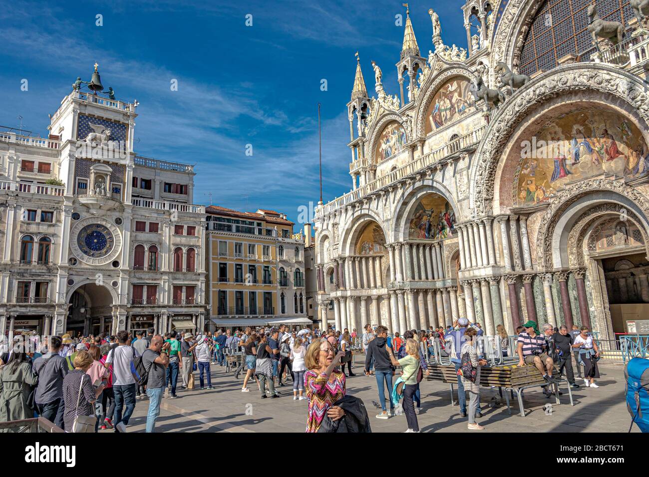 La folla si trova in Piazza San Marco, fuori dalla Basilica di San Marco, una basilica in stile bizantino ornata a Venezia Foto Stock