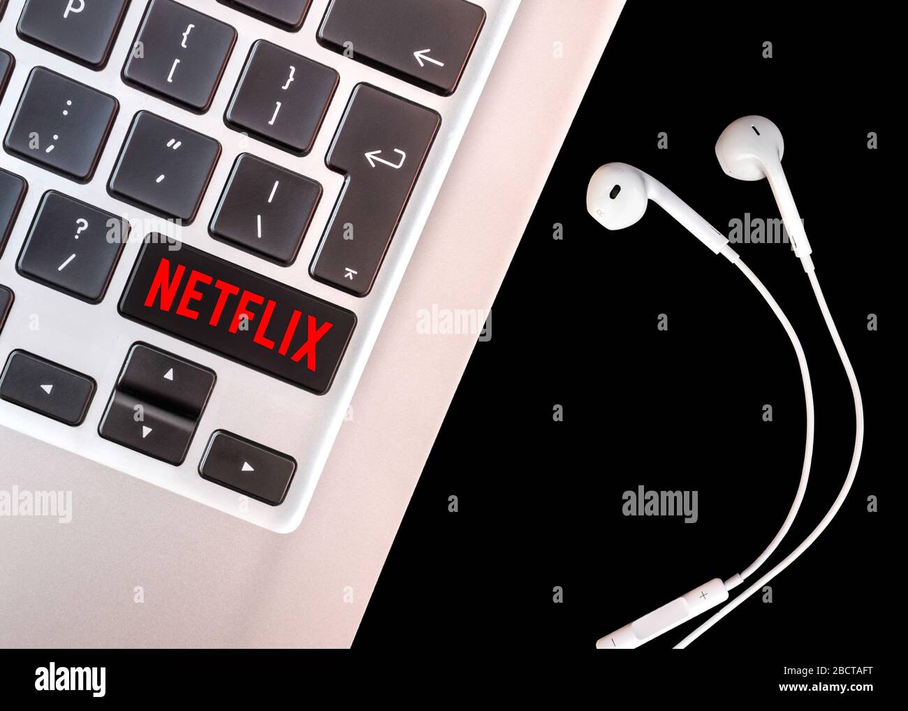 Bruxelles, Belgio - 4 aprile 2020: Logo Netflix su una tastiera per laptop con cuffia. Foto Stock