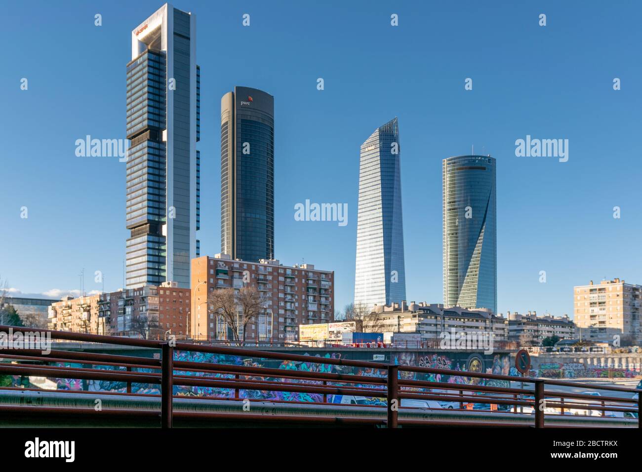 MADRID, SPAGNA - 02 FEBBRAIO 2019: Contrasto tra le quattro torri del quartiere finanziario di Madrid, gli edifici residenziali circostanti e il gra Foto Stock