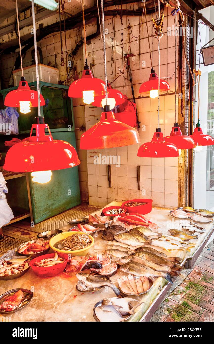 Un negozio che vende una varietà di pesce e frutti di mare nel vecchio quartiere residenziale di Hong Kong, la Baia di Quarry. Vendita di generi alimentari e necessità quotidiane lungo res Foto Stock