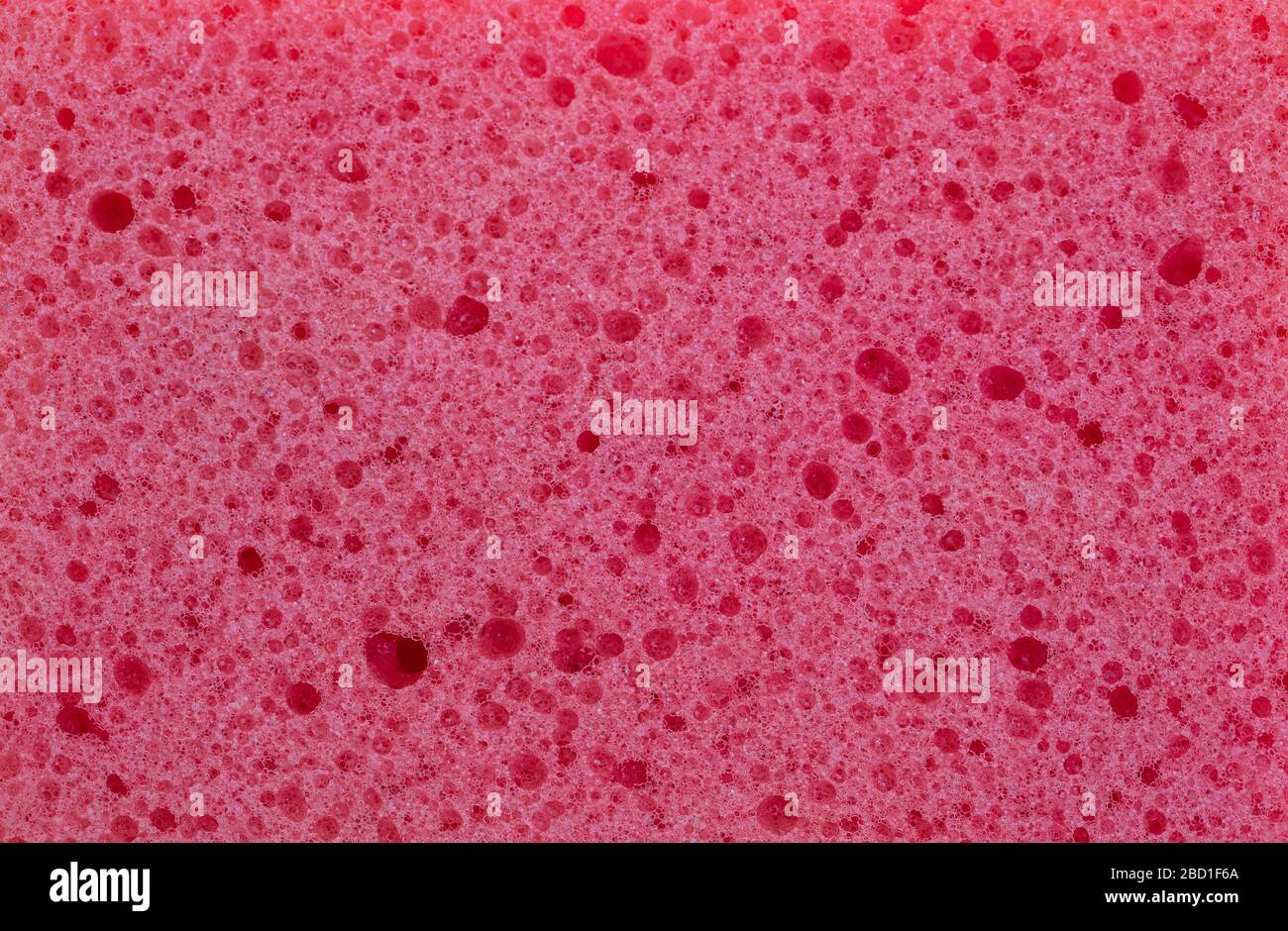 Sfondo tessuto spugna. Spugna per pulizia colore rosa, vista ravvicinata dei dettagli. Servizio di pulizia e bellezza. Macro Foto Stock