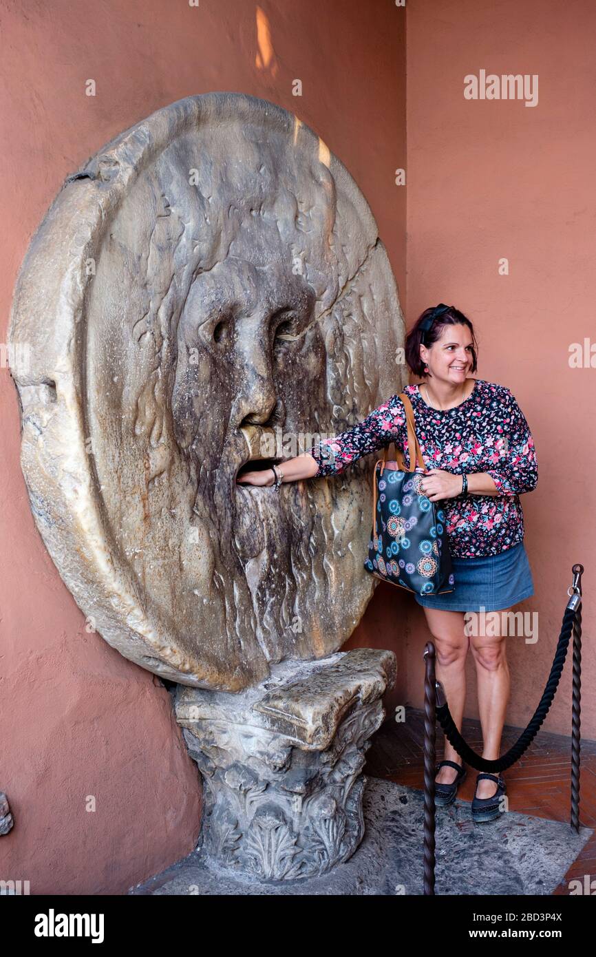 Turismo con mano all'interno della bocca della verità (bocca della Verità), Basilica di Santa Maria in Cosmedin/Basilica di Santa Maria in Cosmedin, Roma, Italia. Foto Stock