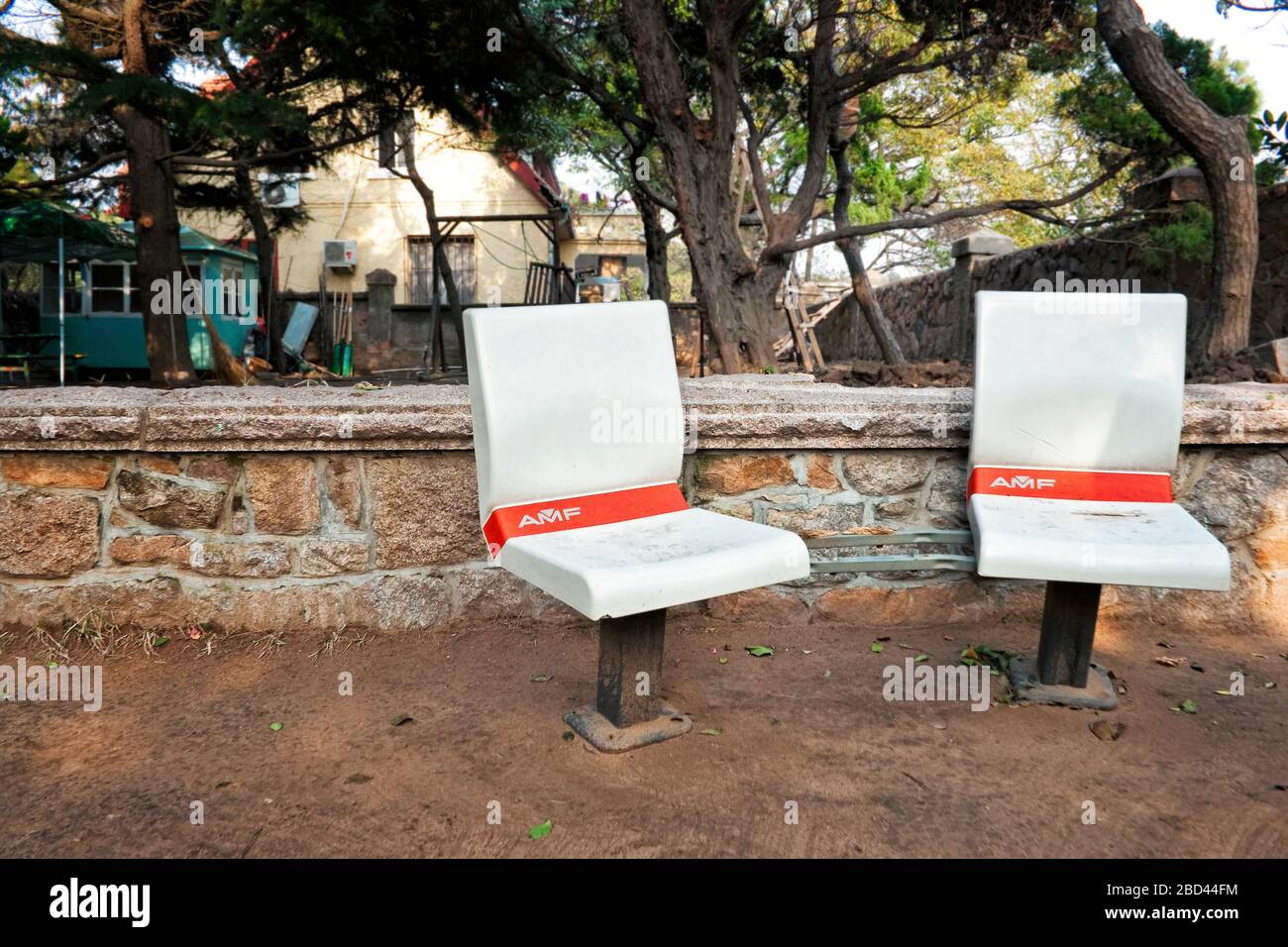Fuori posto le sedie da bowling AMF offrono posti a sedere nel cortile di una casa storica, Qingdao, provincia di Shandong, Cina, Asia, colore Foto Stock Fuori posto le sedie da bowling AMF offrono posti a sedere nel cortile di una casa storica, Qingdao, provincia di Shandong, Cina, Asia, colore Foto Stock