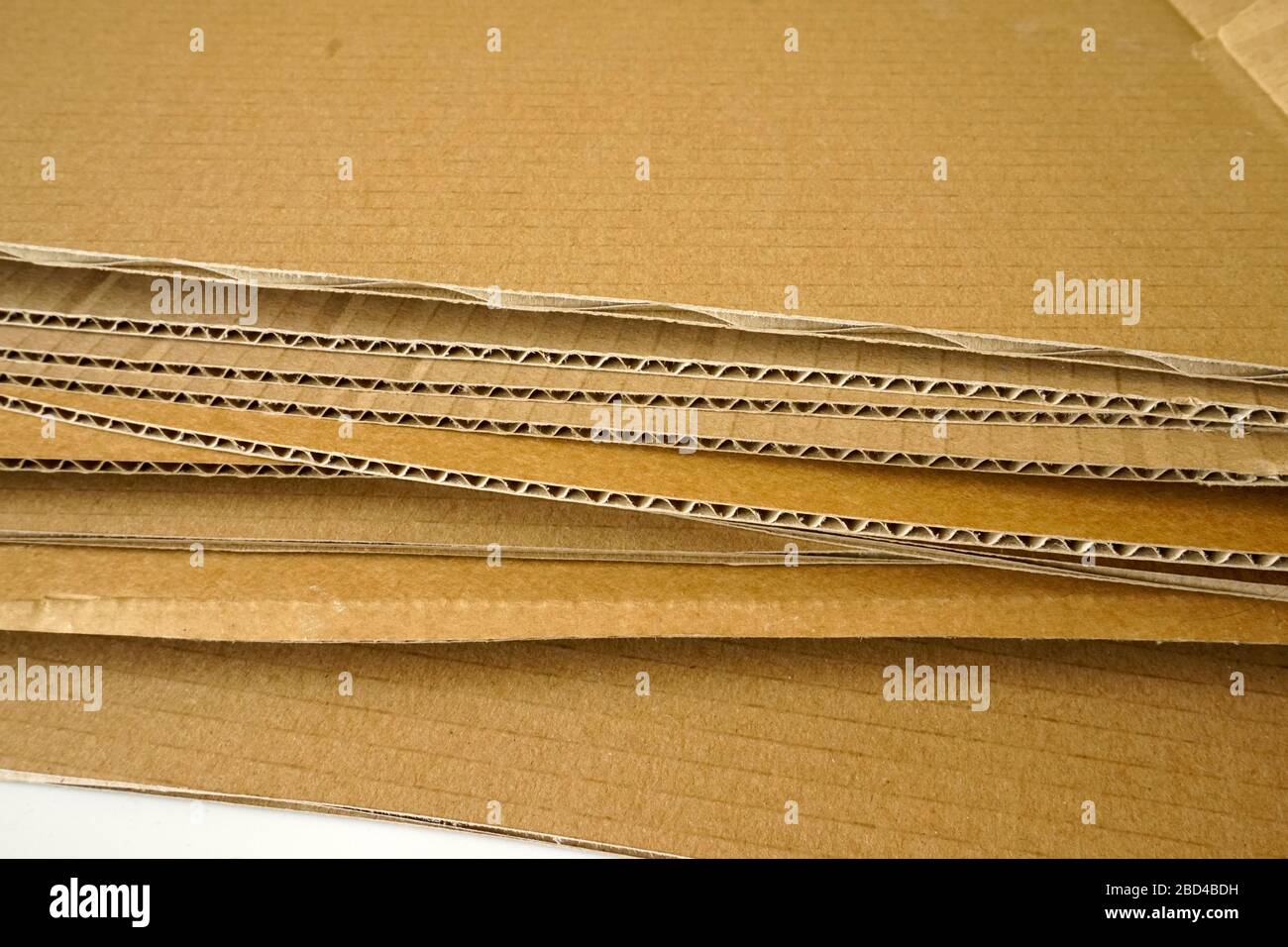 Fogli di cartone ondulato marrone accatastati. Materiale di imballaggio. Foto Stock