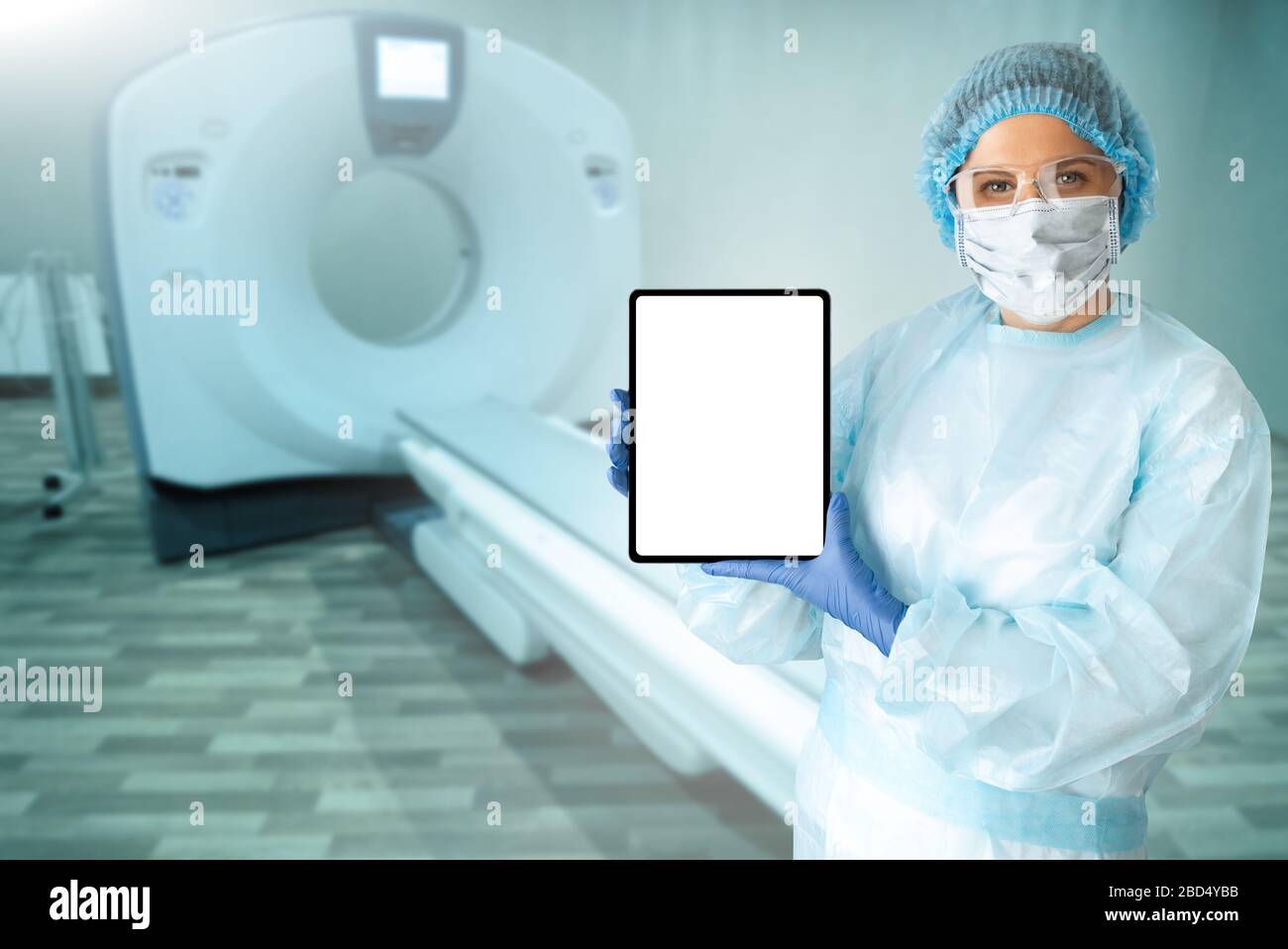 Medico con computer tablet sullo sfondo di una tomografia computerizzata Foto Stock