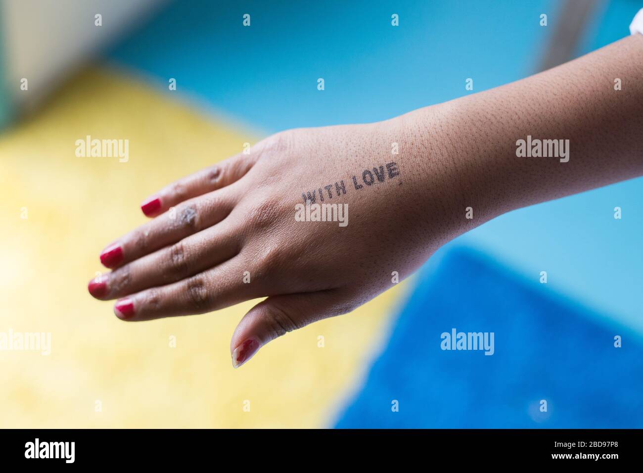 Le parole con amore sono incaparsi sulle mani di una donna Foto Stock