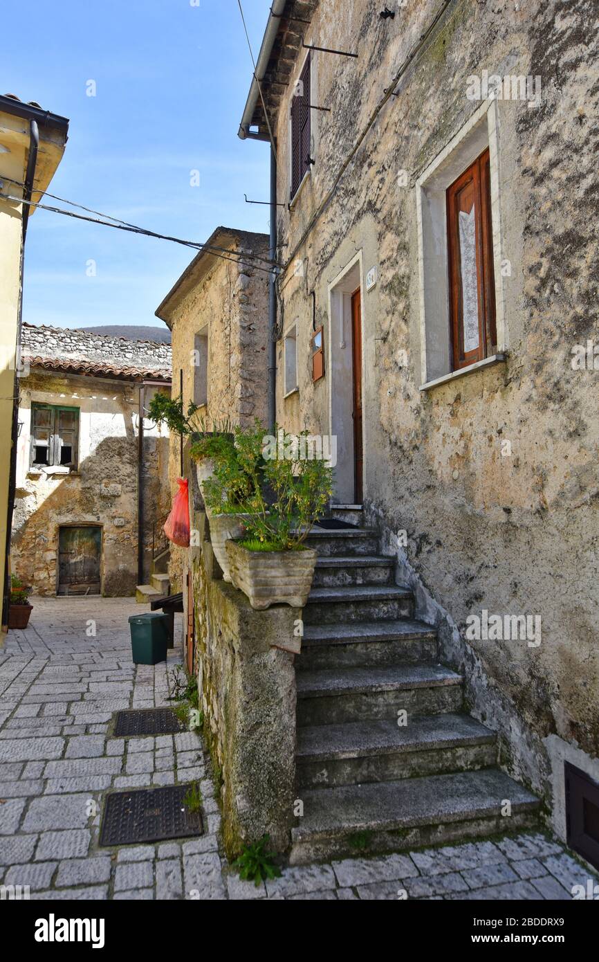 Una strada stretta tra le vecchie case di un villaggio nel sud Italia Foto Stock