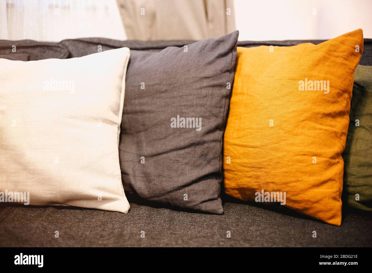 Interno soggiorno con divano grigio e cuscini gialli. Sfondo accogliente Foto Stock