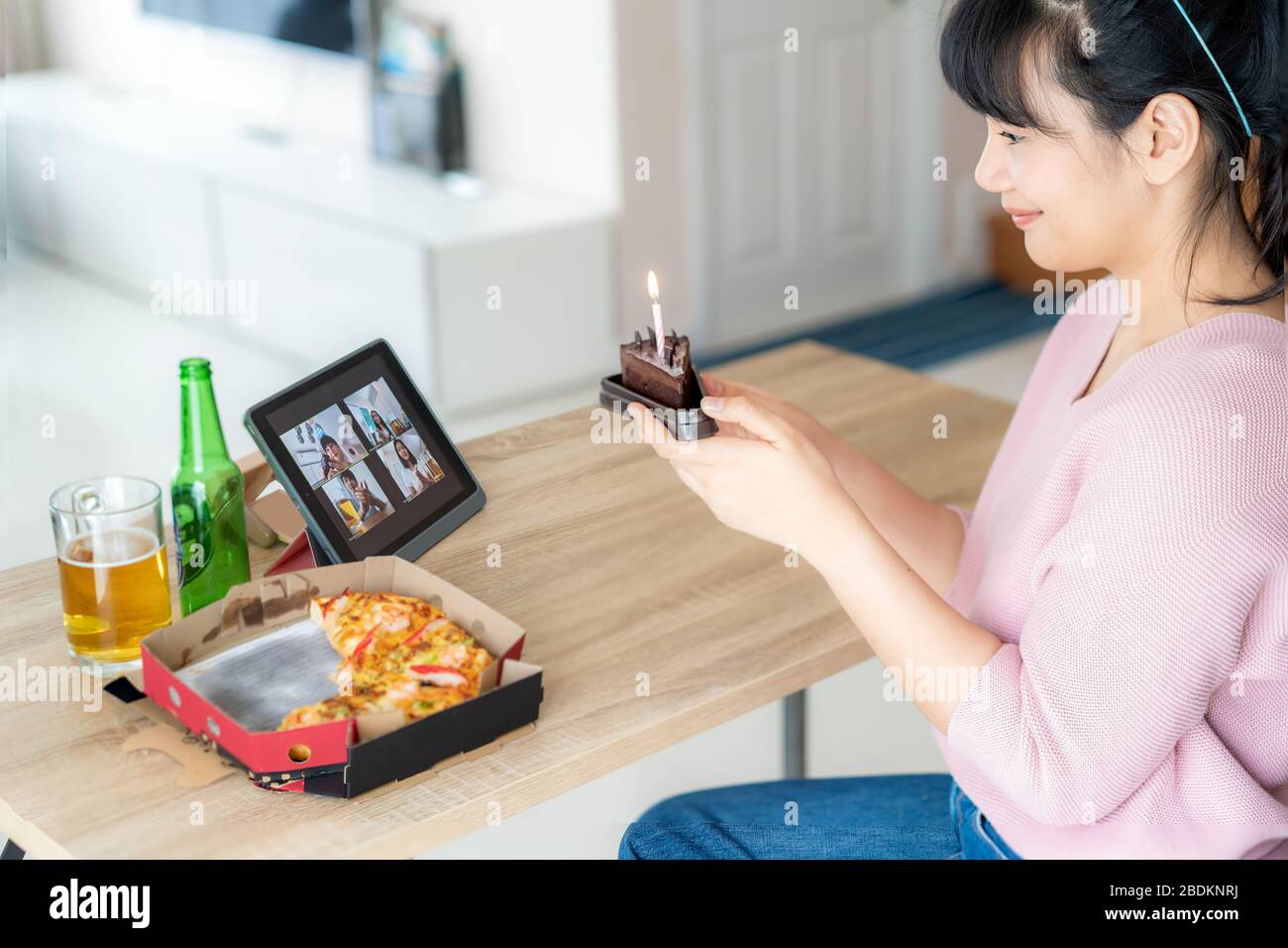 Asian donna virtuale happy hour riunione compleanno party con torta online insieme al suo amico in videoconferenza con tablet digitale per una m online Foto Stock