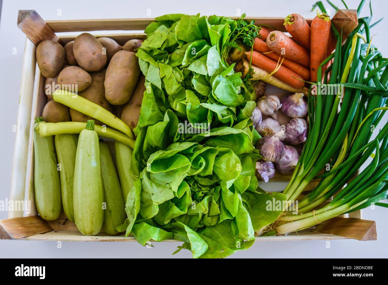 Verdure biologiche poste in una cassa pronta per la spedizione o da preparare per un pasto di insalata salutare o una bevanda di disintossicazione con vitamine frullato Foto Stock